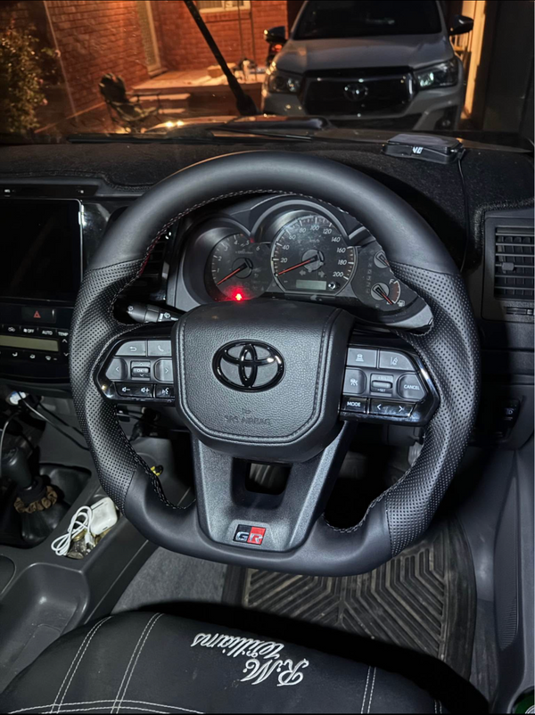 Steering wheel of a Toyota vehicle with dashboard details