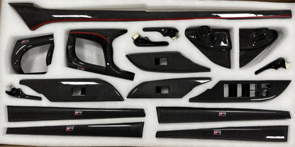 Set of carbon fiber car interior panels in a packaging box.